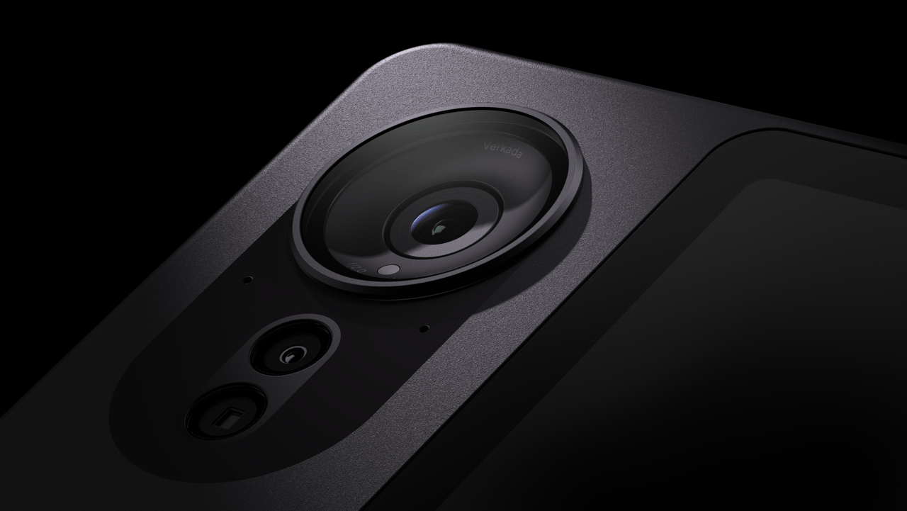Close-up product shot of a Verkada dome security camera lens against dark background.