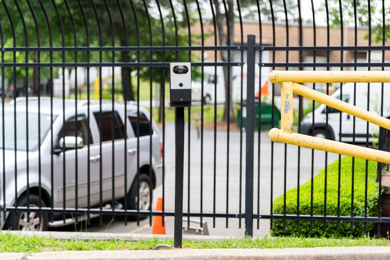 Verkada intercom device mounted on a post at a gated parking lot entrance.